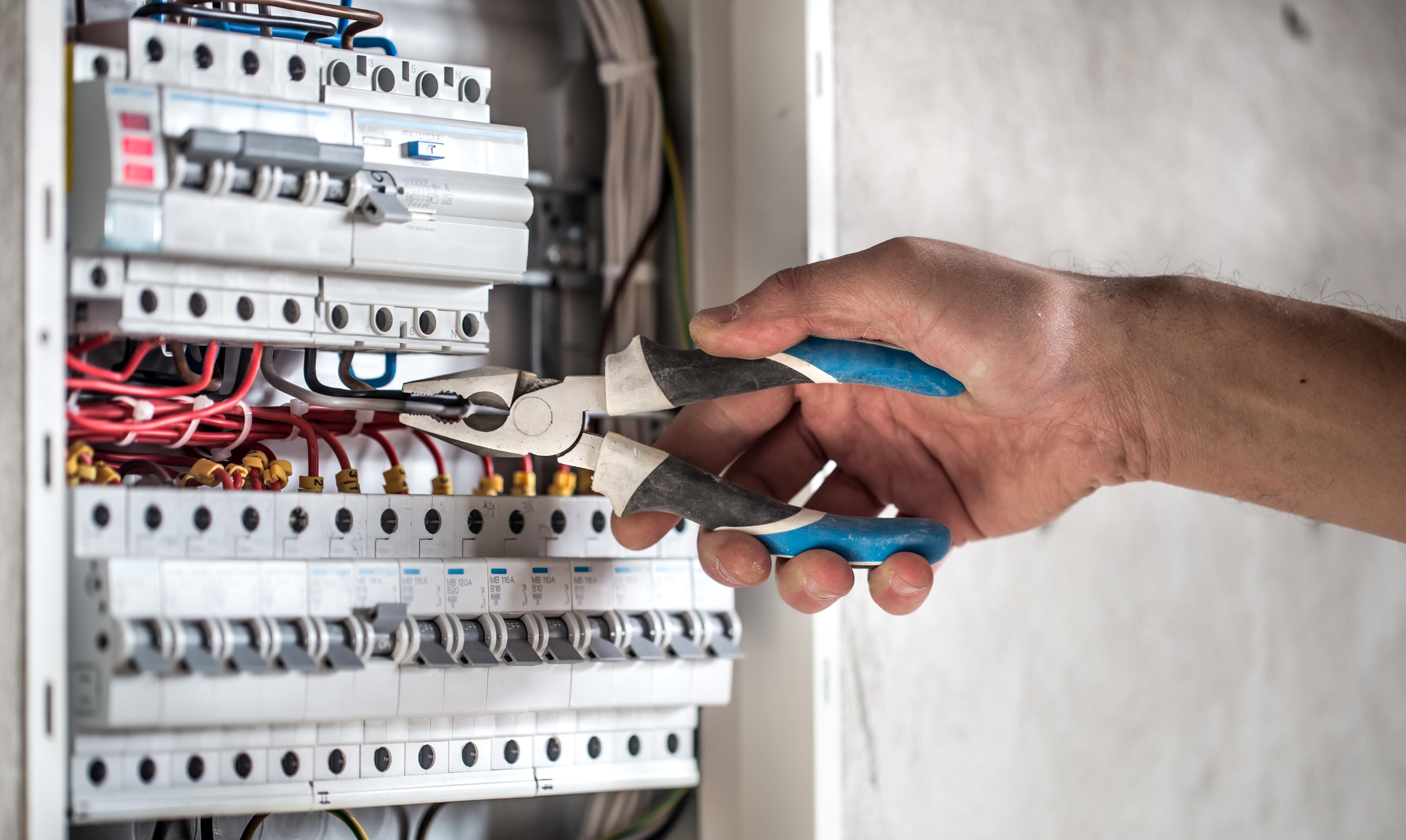 Electrician carrying out electrical work